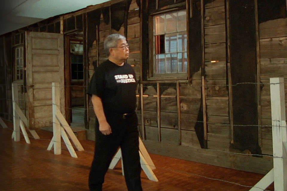 man looking at barrack in museum