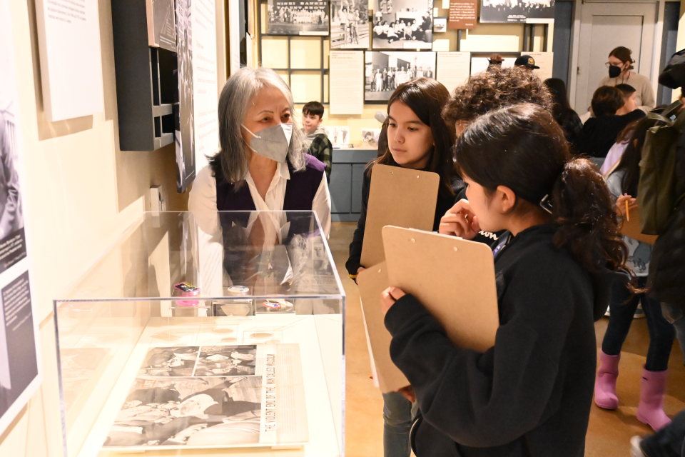 volunteer giving students tour of museum