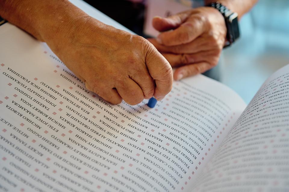 hands stamping the ireicho book