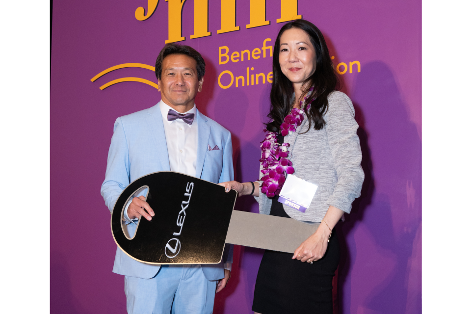 Rick Noguchi and guest holding winning key Lexus raffle winner 