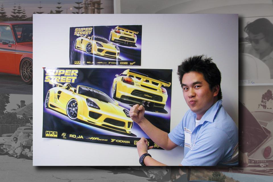 Jonathan Wong in front of Motortrend magazine spreads