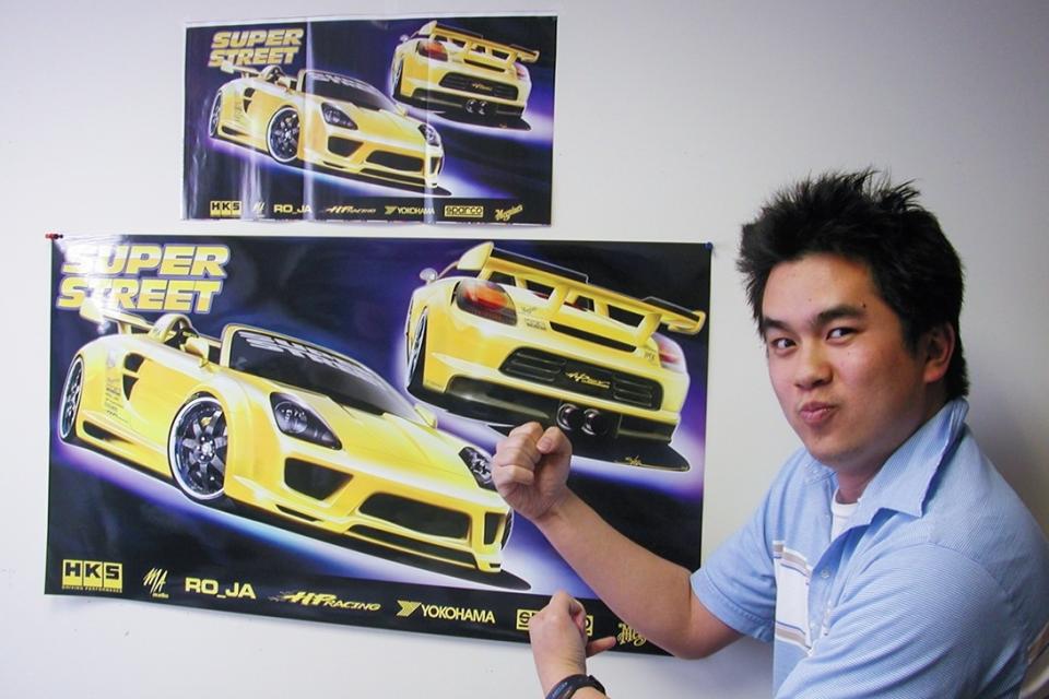 Jonathan Wong in front of Motortrend magazine spreads