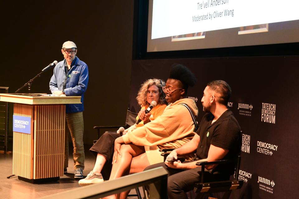panel talking with moderator at event