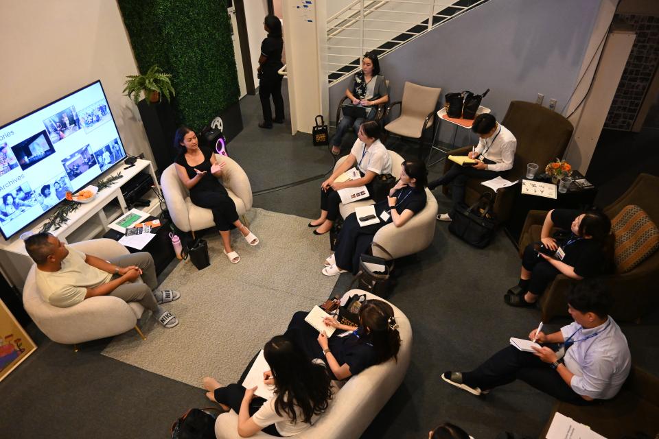 Group of people sitting in chairs in discussion