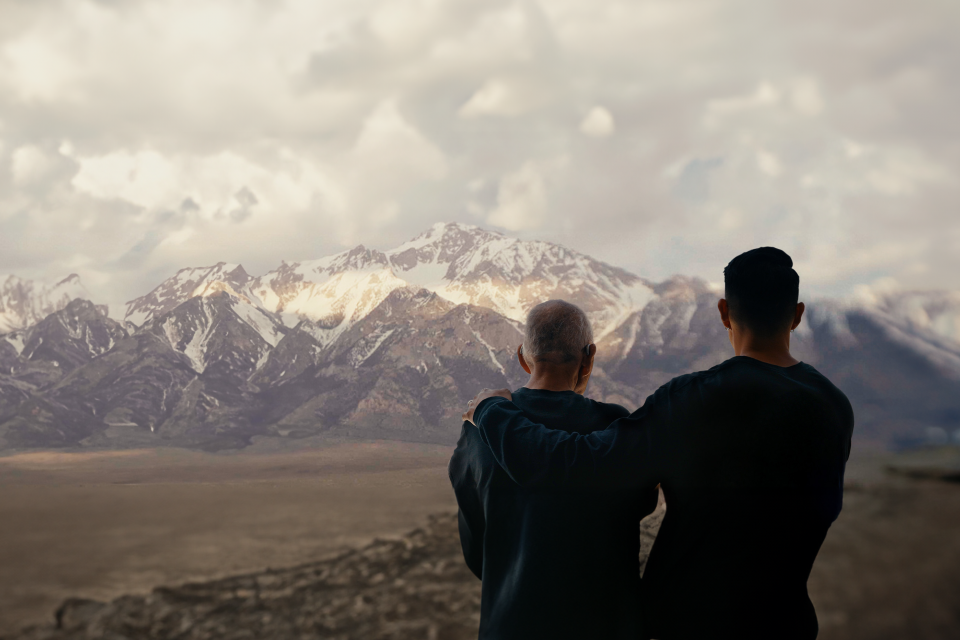 Father and son looking at the mountains behind Manzanar concentration camp