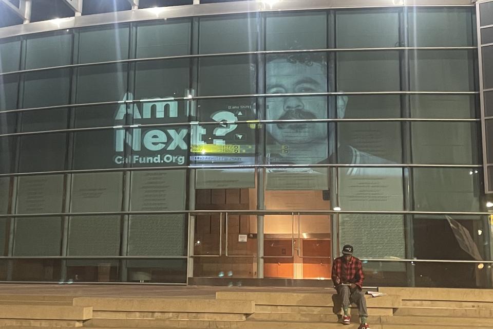 Am I next? projection of people taken away by ICE on museum building