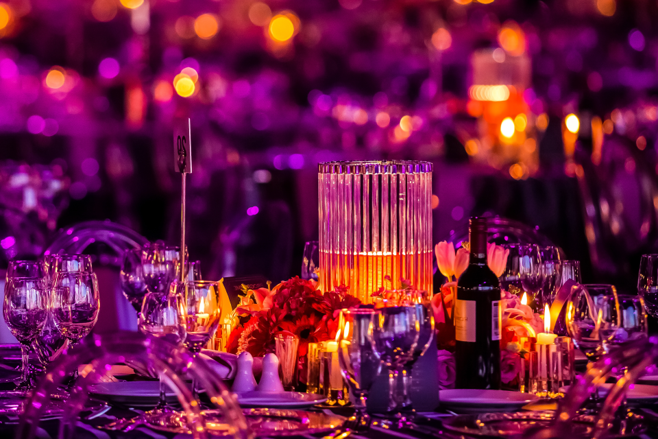 crystal table setting in purple lighting and candles