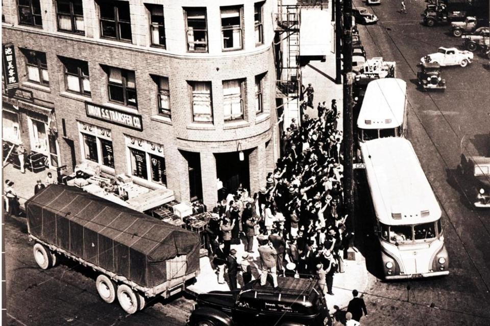 Jack Iwata photograph, 1942. Bird's eye view of the Nishi Hongwanji Buddhist Temple, currently the Museum's Historic Building, as Japanese Americans are subjected to forced removal and incarceration.