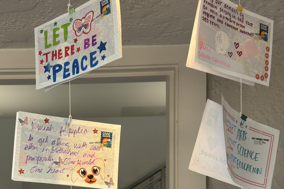 wish wall postcards hanging display in window