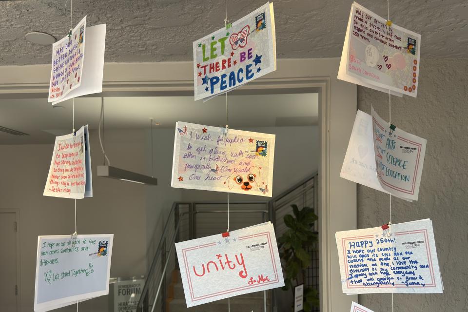 wish wall postcards hanging display in window