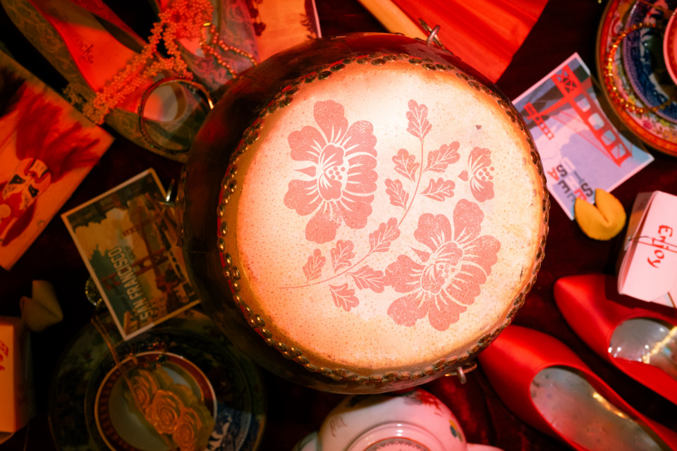Photo of various objects, Chinese drum with flower print, take out box, dress shoes etc 