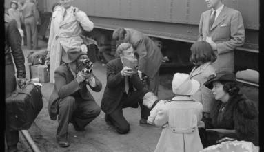 black and white photo of Photographers at the train taking Japanese-Americans to Owens Valley