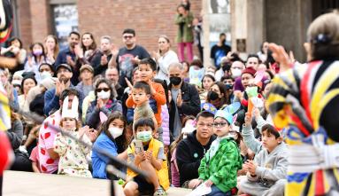 A crowd of children watching a Kodama Taiko performance at the 2023 Oshogatsu Family Festival on JANM's plaza