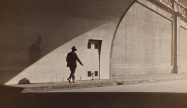 man walking out of tunnel