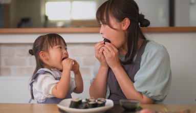 mom and daughter eating japanese food together