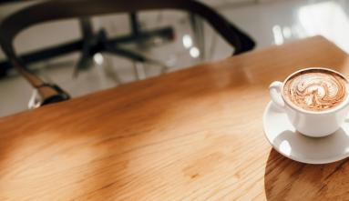 a cup of coffee sitting on table